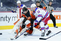 Philadelphia Flyers' Erik Gustafsson (56) and New York Rangers' Alexis Lafreniere (13) battle for the puck during the second period of an NHL hockey game, Wednesday, Feb. 24, 2021, in Philadelphia. (AP Photo/Matt Slocum)