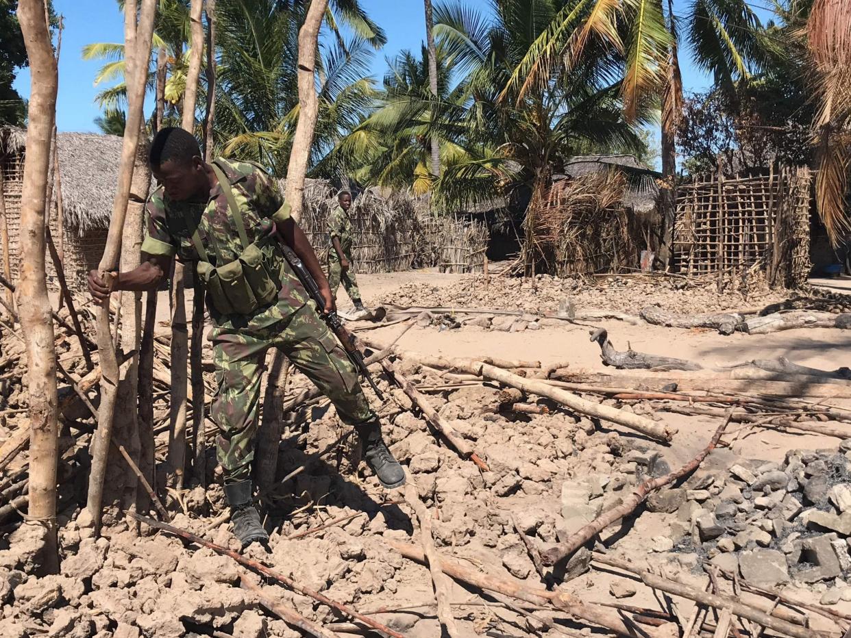 Soldiers bring down a structure, torched by militants, to be rebuilt as shelter for people fleeing the recent violence: AFP/Getty