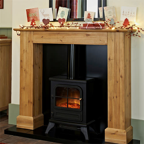 <b>Ashdown Stove suite </b><br><br>A country style lounge calls for a traditional wooden fireplace. This surround features a distressed finish, adding to the rustic look - and best of all comes with the black electric stove shown, offering a cosy ‘open fire’ glow with none of the mess. <br><br>£599, <b><a href="http://www.next.co.uk/g48678s1#780455g48" rel="nofollow noopener" target="_blank" data-ylk="slk:Next;elm:context_link;itc:0;sec:content-canvas" class="link ">Next</a></b>