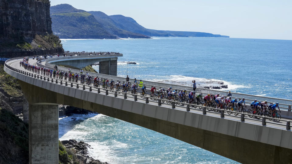 Riders cross the Sea Cliff Bridge during the elite men's road race at the world road cycling championships in Wollongong, Australia, Sunday, Sept. 25, 2022. (AP Photo/Rick Rycroft)