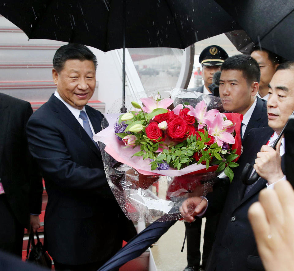China's President Xi Jinping receives a bunch of flowers on his arrival at Kansai International Airport in Izumisano, Osaka prefecture, western Japan, Thursday, June 27, 2019. Group of 20 leaders gather in Osaka on June 28 and 29 for their annual summit.(Kyodo News via AP)