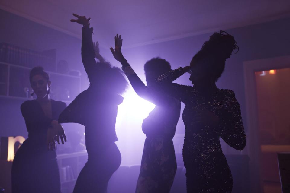 young women dancing and cheering at home party