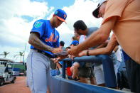 <p>New York Mets minor league pitcher Tyler Bashlor signs for fans before the baseball game against the Houston Astros at the Ballpark of the Palm Beaches in West Palm Beach, Fla., on Feb. 26, 2018. (Photo: Gordon Donovan/Yahoo News) </p>