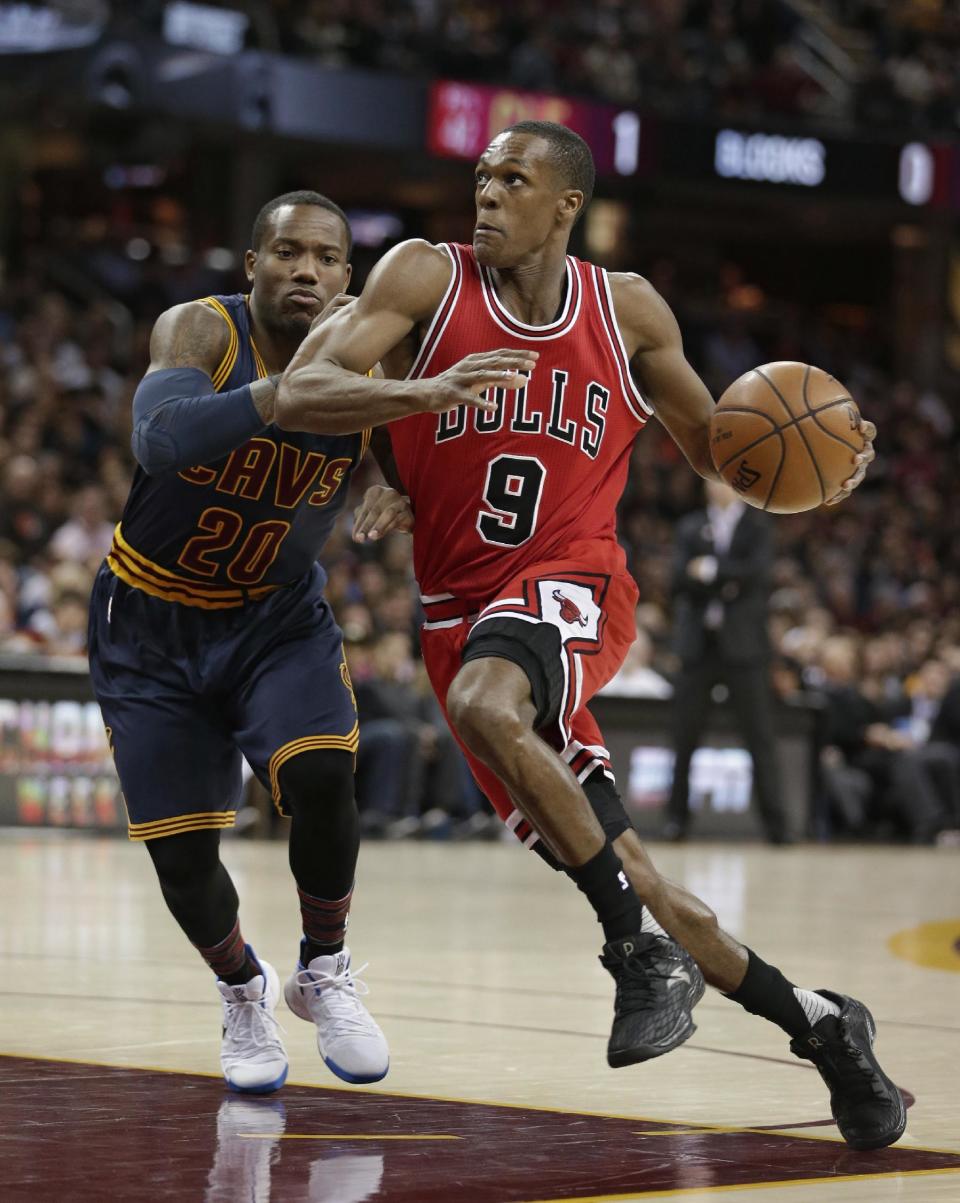 Chicago Bulls' Rajon Rondo (9) drives past Cleveland Cavaliers' Kay Felder (20) during the first half of an NBA basketball game, Saturday, Feb. 25, 2017, in Cleveland. (AP Photo/Tony Dejak)