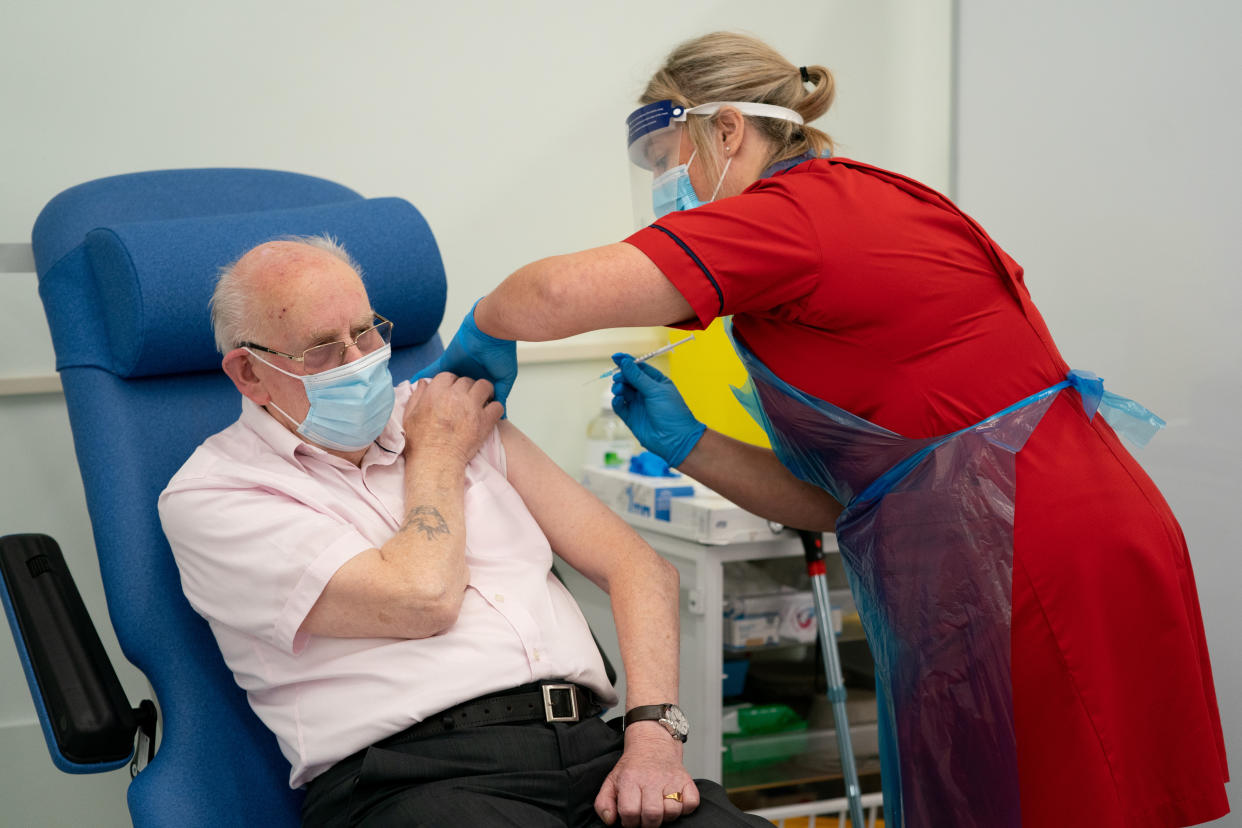 General manager of Covid Recovery Becky Board administers the hospital's first Pfizer-BioNTech Covid-19 vaccine to George Dyer, 90, in The Vaccination Hub at Croydon University Hospital, south London, on the first day of the largest immunisation programme in the UK's history. Care home workers, NHS staff and people aged 80 and over began receiving the jab this morning.