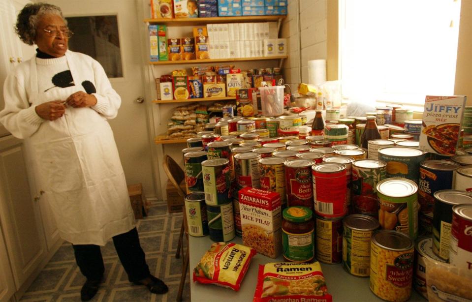 Barbara Long looks at the bounty from 35 sacks of groceries donated by St. Francis of Asissi Church of West Des Moines at the Eddie Davis Community Center, Saturday, March 13, 2004, in West Des Moines. The church had called Long, who runs the food pantry, asking what she needed and stocked the pantry to overflowing. Food is given out at the pantry on Tuesday and Thursday evenings at dinner time.