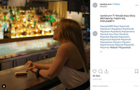 A woman holds a "heated tobacco" IQOS device, made by Philip Morris International, in an Instagram post under an account called @iqostyle.arm, which has the hashtag #iqosarmenia, in a post from May 12, 2019. @iqostyle.arm/Social Media via REUTERS