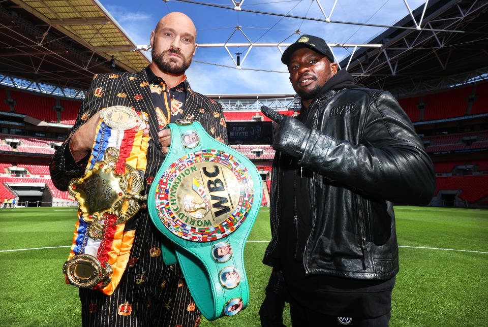 LONDON, ENGLAND - APRIL 20: Tyson Fury (L) and Dillian Whyte (R) face-off during the press conference prior to their WBC heavyweight championship fight at Wembley Stadium on April 20, 2022 in London, England. (Photo by Mikey Williams/Top Rank Inc via Getty Images)