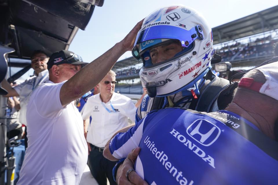 Graham Rahal is consoled by a crew member and his dad, Bobby Rahal, after Rahal was bumped from the Indianapolis 500 auto race at Indianapolis Motor Speedway, Sunday, May 21, 2023, in Indianapolis. (AP Photo/Darron Cummings)