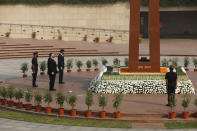 U.S. Secretary of State Mike Pompeo, foreground, and Secretary of Defence Mark Esper pay their tributes at the National War Memorial in New Delhi, India, Tuesday, Oct. 27, 2020. In talks on Tuesday with their Indian counterparts, Pompeo and Esper are to sign an agreement expanding military satellite information sharing and highlight strategic cooperation between Washington and New Delhi with an eye toward countering China. (Adnan Abidi/Pool via AP)