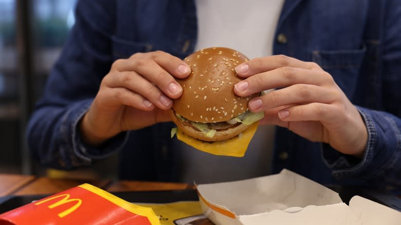 man eating hamburger