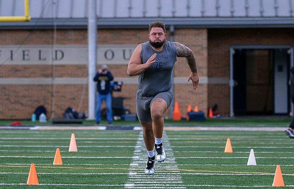 Shepherd University offensive lineman Joey Fisher runs a 40-yard dash for NFL scouts at Pro Day.