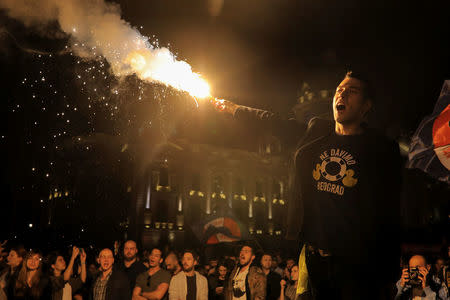 A protester lights a flare during a protest against Prime Minister Aleksandar Vucic's government in Belgrade, Serbia April 25, 2017. REUTERS/Marko Djurica