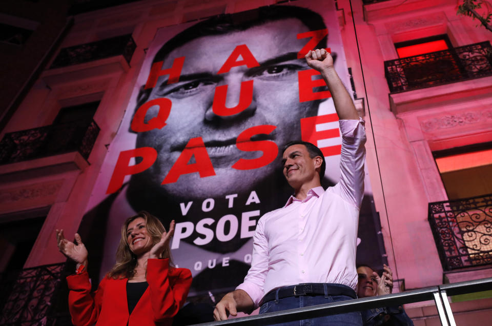 Spain's Prime Minister and Socialist Party leader Pedro Sanchez gestures to supporters outside the party headquarters following the general election in Madrid, Spain, Sunday, April 28, 2019. A divided Spain voted Sunday in its third general election in four years, with all eyes on whether a far-right party will enter Parliament for the first time in decades and potentially help unseat the Socialist government. At left is Sanchez wife Maria Begona Gomez.(AP Photo/Bernat Armangue)