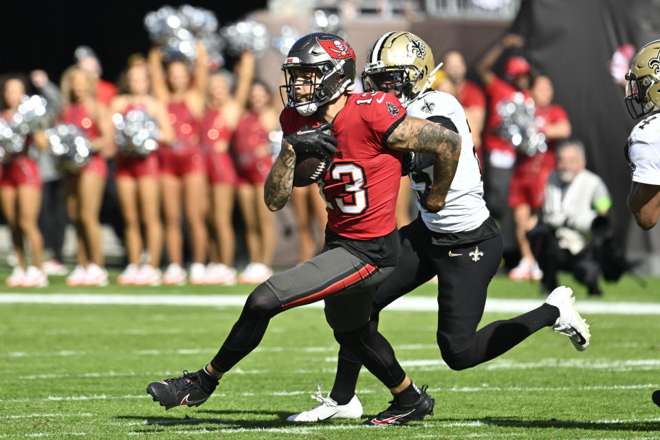 Tampa Bay Buccaneers wide receiver Mike Evans (13) carries in the first half of an NFL football game against the Tampa Bay Buccaneers in Tampa, Fla., Sunday, Dec. 31, 2023. (AP Photo/Jason Behnken)