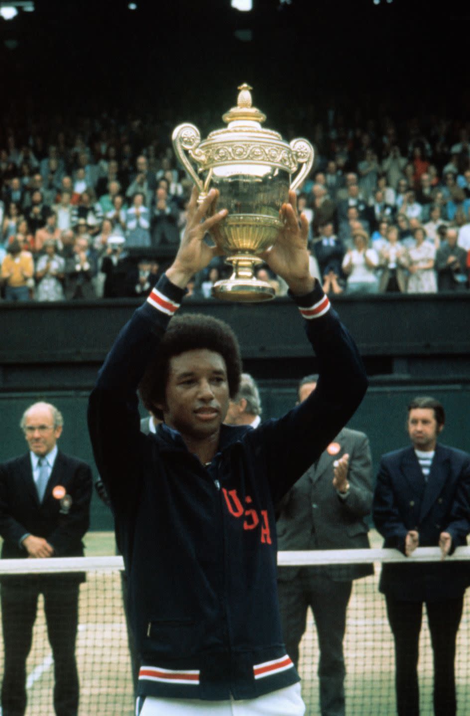 <p>Arthur Ashe holds up his Wimbledon trophy after defeating Jimmy Connors in the Men's Singles championship 6-1, 6-1, 5-7, 6-4. in 1975.</p>