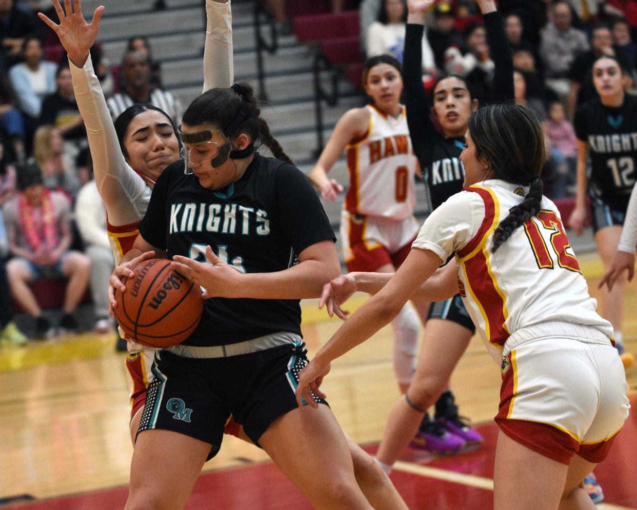 Caitlin Turnbow (Black) gets surrounded by the Centennial defense as Organ Mountain played Centennial in the first round of the Class 5A playoffs