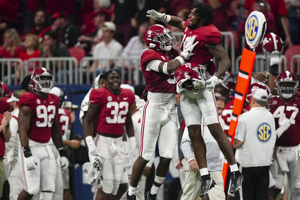 Alabama defensive back Jordan Battle (9) celebrates his interception and touchdown against Georgia during the second half of the Southeastern Conference championship NCAA college football game, Saturday, Dec. 4, 2021, in Atlanta. (AP Photo/John Bazemore)