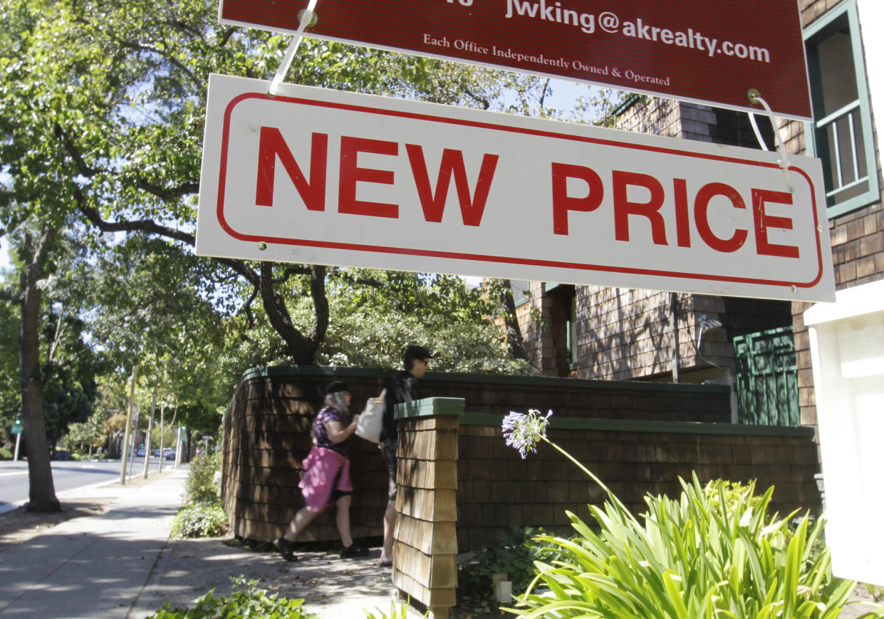 A new price sign hangs near a home for sale in Palo Alto, Calif. (Credit: Paul Sakuma, AP Photo)
