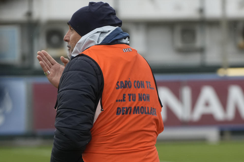 Napoli coach Luciano Spalletti wears a bib reading: " I will be with you and you don't have to give up" during a training session at the club headquarters in Castel Volturno, near Naples, Wednesday, April 5, 2023. Unlike other major cities in Italy, Naples has only one major soccer team and the fan support for Napoli is felt on every street and alleyway. Lobotka, who developed with Ajax’s junior squad and then played for Danish club Nordsjaelland and Spanish side Celta Vigo before transferring to Italy, had never experienced anything like Napoli.(AP Photo/Gregorio Borgia)