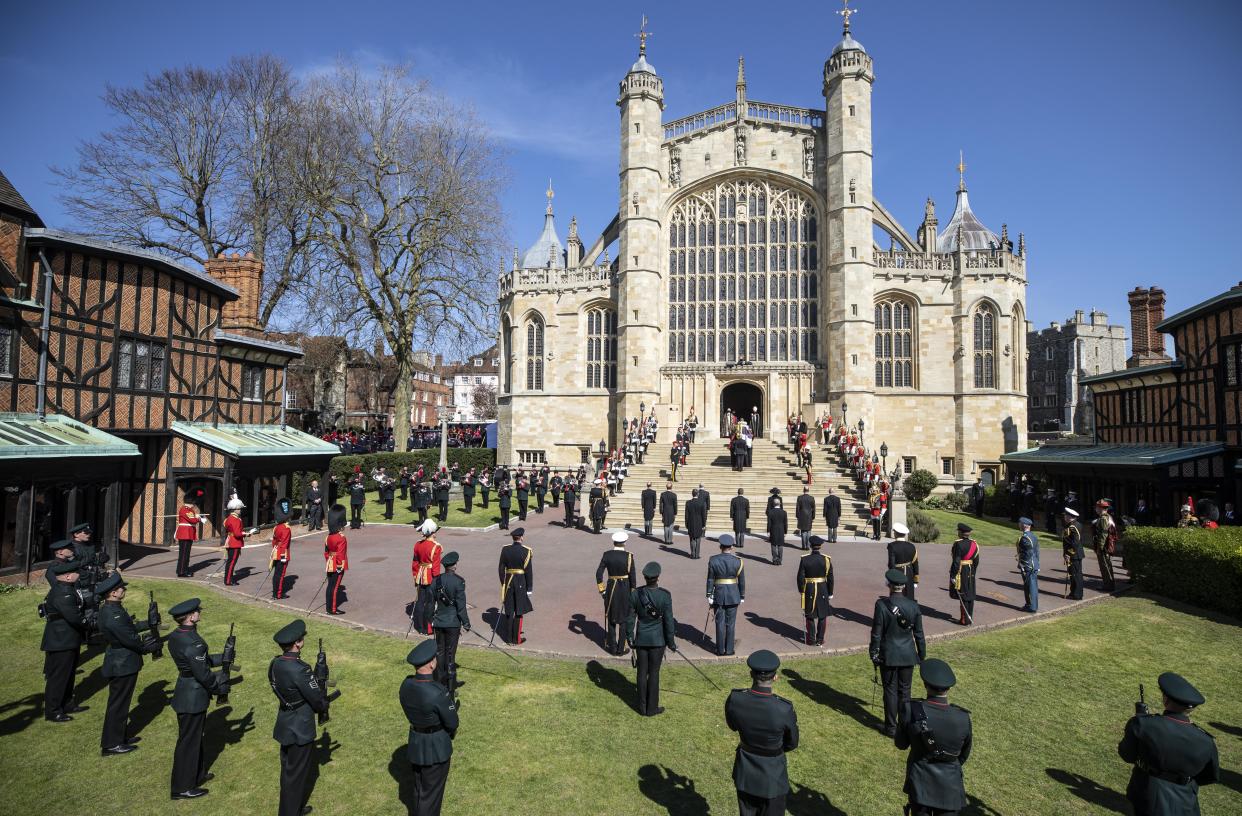 WINDSOR, ENGLAND - APRIL 17: Members of the royal family watch as Prince Philip, Duke of Edinburgh’s coffin, covered with His Royal Highness’s Personal Standard arrives at St George’s Chapel carried by a bearer party found by the Royal Marines during the funeral of Prince Philip, Duke of Edinburgh at Windsor Castle on April 17, 2021 in Windsor, England. Prince Philip of Greece and Denmark was born 10 June 1921, in Greece. He served in the British Royal Navy and fought in WWII. He married the then Princess Elizabeth on 20 November 1947 and was created Duke of Edinburgh, Earl of Merioneth, and Baron Greenwich by King VI. He served as Prince Consort to Queen Elizabeth II until his death on April 9 2021, months short of his 100th birthday. His funeral takes place today at Windsor Castle with only 30 guests invited due to Coronavirus pandemic restrictions. (Photo by Richard Pohle - WPA Pool/Getty Images)