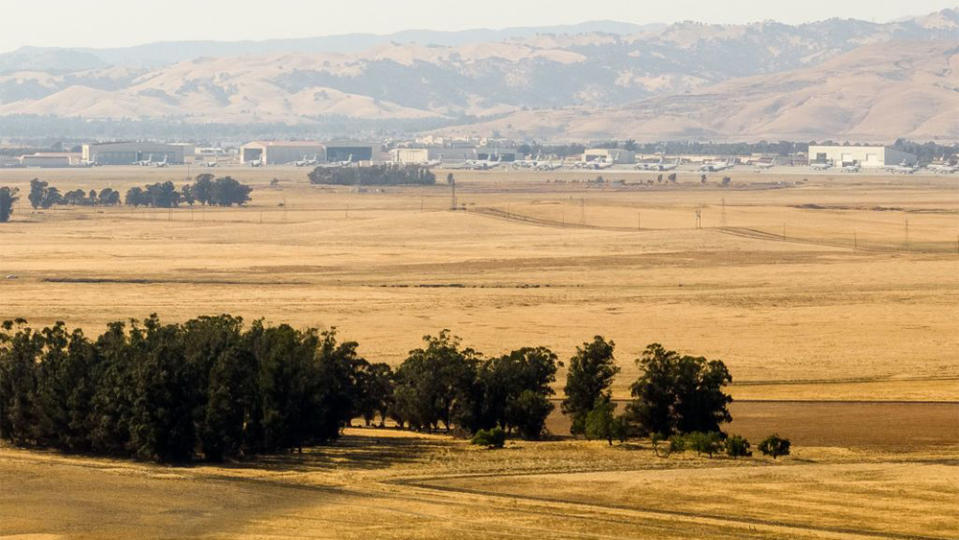 In this aerial photo, a parcel of land recently purchased by Flannery Associates is seen with Travis Air Force base in the background near Rio Vista, California on September 15, 2023. A stealth campaign by Silicon Valley elites with a dream of turning a swath of California farmland into a new age city has ranchers who live here challenging their tactics as well as their motives. The project first surfaced when a mysterious buyer started gobbling up parcels of land in this rural outback between San Francisco and Sacramento. The buyer, first revealed by the New York Times in August, turned out to be a secretive outfit called Flannery Associates. (Photo by JOSH EDELSON / AFP) (Photo by JOSH EDELSON/AFP via Getty Images)