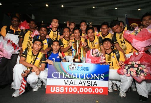 File picture. The victorious Malaysian football team pose with the AFF Suzuki Cup in December 2010. The Tigers showed bite in that tournament when they overcame a poor start to win the Southeast Asian title for the first time with a 4-2 aggregate victory over Indonesia in the final