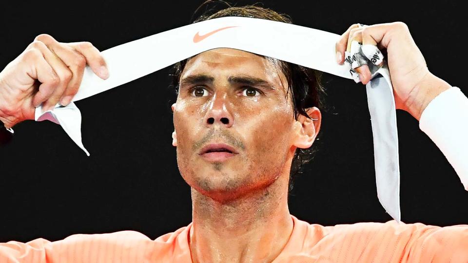 Rafa Nadal (pictured) putting on his headband during the Australian Open.