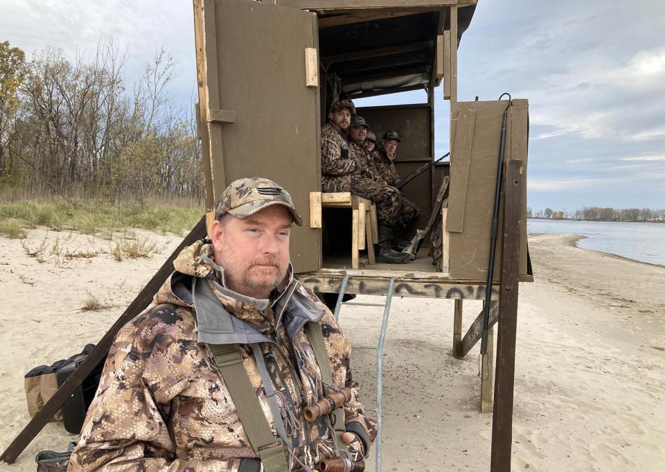 Shawn Feiock, 52, stands outside his duck blind at Presque Isle State Park's Beach 11 during the opening day of duck hunting season Nov. 6. Sitting inside the blind are, from left to right: Corey Wolbert, 35; Eric Kraus, 52; Konnor Kraus, 14; and Gary Nuber, 71.