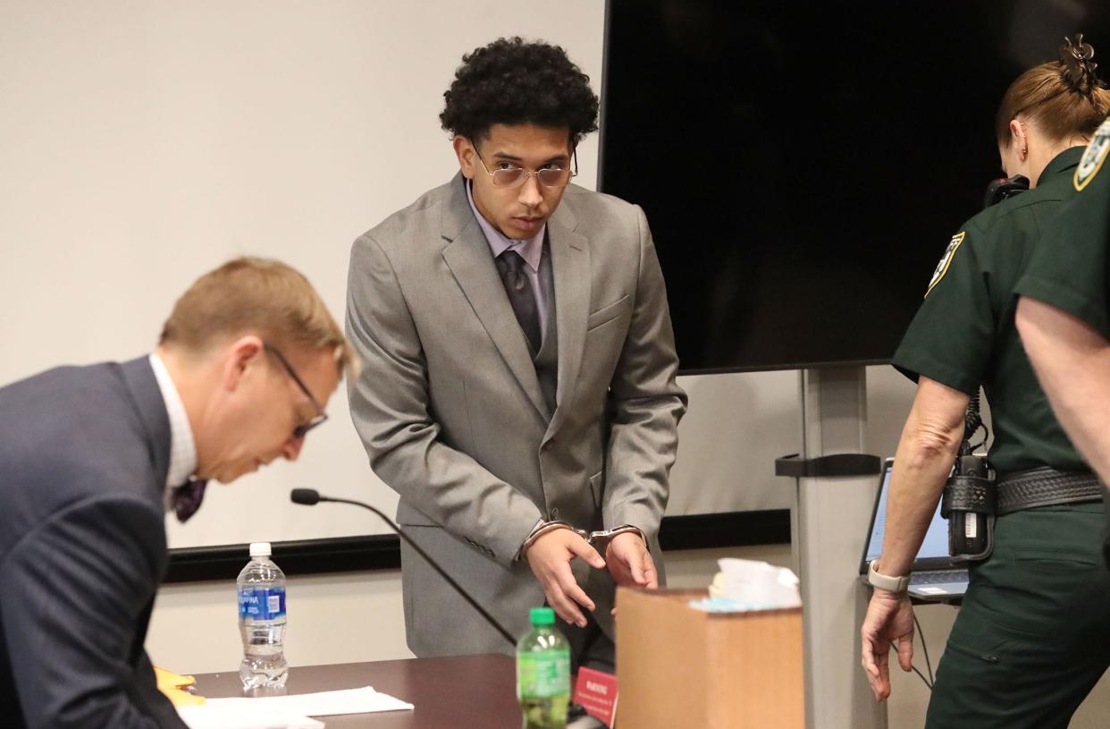 James Powell talks to his attorney before a VCSO bailiff escorts him back to a holding cell during a break in his first-degree murder trial, Tuesday, March 7, 2023, at the S. James Foxman Justice Center.