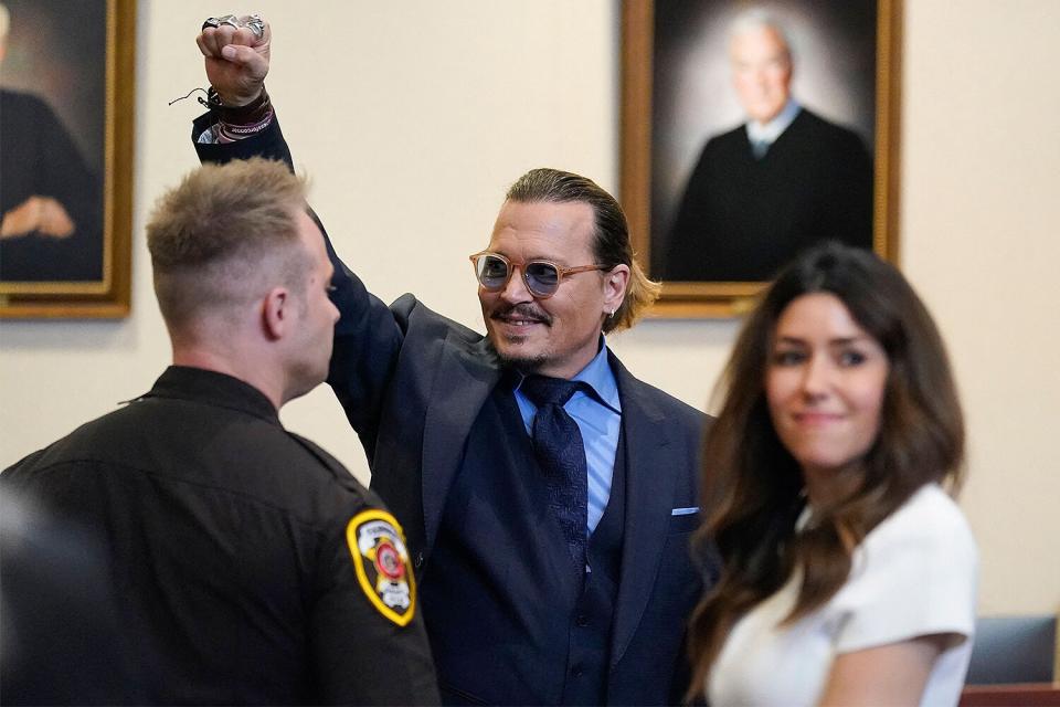 Actor Johnny Depp gestures to spectators in court after closing arguments at the Fairfax County Circuit Courthouse in Fairfax, Virginia, on May 27, 2022. - Actor Johnny Depp is suing ex-wife Amber Heard for libel after she wrote an op-ed piece in The Washington Post in 2018 referring to herself as a public figure representing domestic abuse