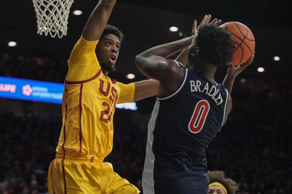 USC's Joshua Morgan, left, defends against Arizona's Jaden Bradley.