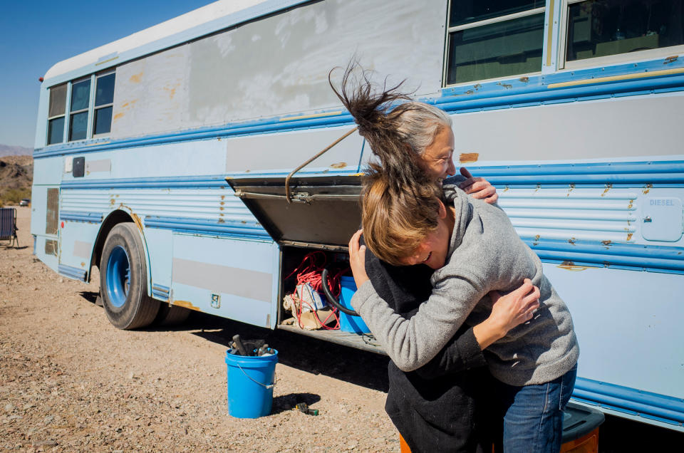 Paula and Max embrace after working on construction projects for the bus on Feb. 20. They’re careful to clean up after themselves after renovations. Paula says that, in her experience, people living out of skoolies or vans are usually the most respectful towards the land itself. “The people who stay and do full time living, they would like to keep the privilege,” she explains. “[We're] usually the ones that go out and clean up after all of the people that leave stuff behind.”<span class="copyright">Nina Riggio for TIME</span>