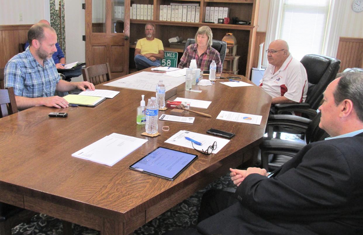 Holmes County Economic Development Director Mark Leininger (at left) explains the lates enterprise zone agreement to commissioners Dave Hall (right) and Ray Eyler, and clerk Susan Schie.