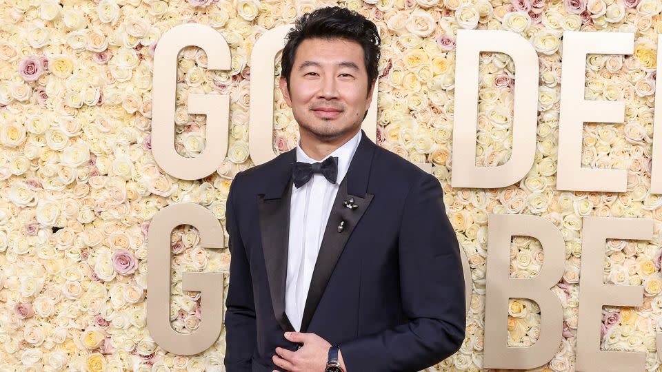 “Barbie” actor Simu Liu wore a navy-blue Givenchy jacket and matching trousers, a white cotton poplin shirt and a black silk satin bow tie. - John Salangsang/Golden Globes/Getty Images