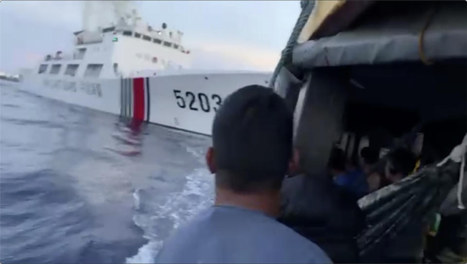 In this image from a video released by the Armed Forces of the Philippines, Filipino sailors look after a Chinese coast guard ship with bow number 5203 bumps their supply boat as they approach Second Thomas Shoal, locally called Ayungin Shoal, at the disputed South China Sea on Sunday Oct. 22, 2023. (Armed Forces of the Philippines via AP)