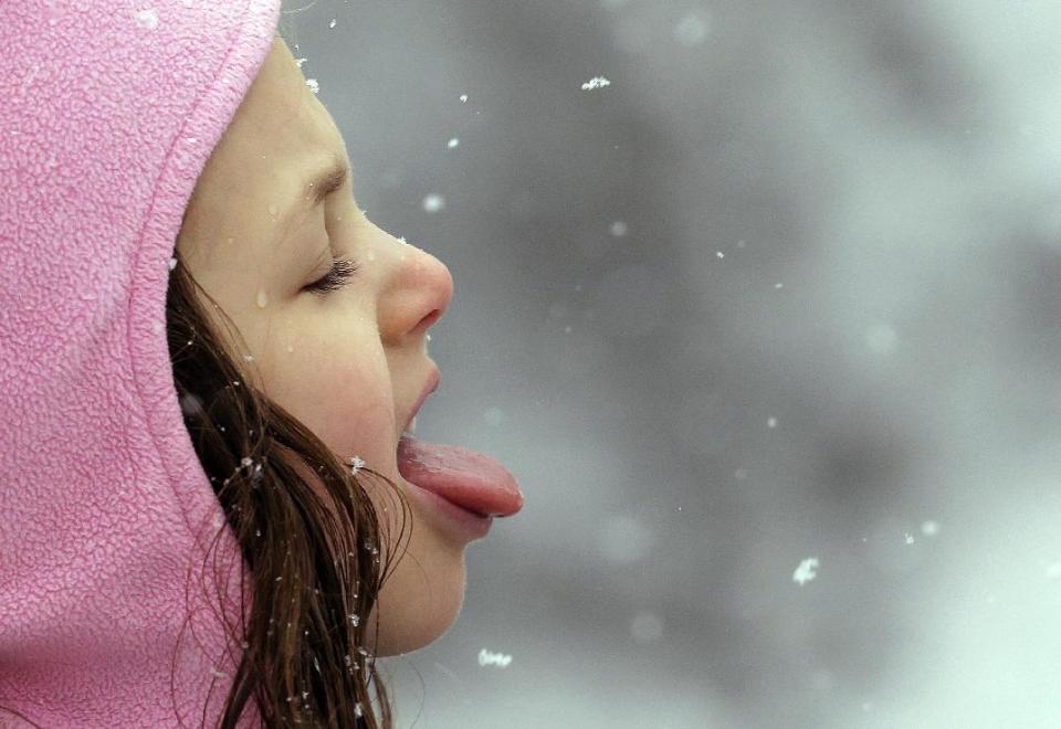 Penny Austin, 5, tries to catch snowflakes on her tongue during a winter storm moving through the area, Monday, Feb. 6, 2017, in Seattle. Seattle finally got its dose of winter weather, with an overnight storm that left snow totals of an inch to more than a foot across western Washington, causing widespread school closures Monday. More than 75,000 Puget Sound Energy and Seattle City Light customers were without power. A winter storm warning remains in effect for the greater Puget Sound Metro area. (AP Photo/Elaine Thompson)