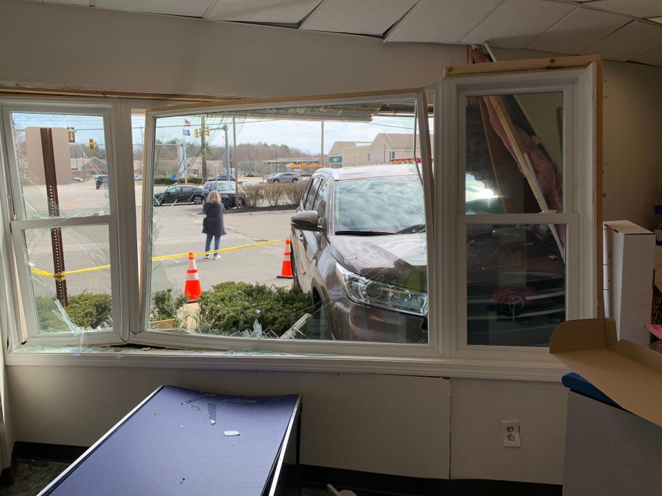 Damage seen from the inside of the North Hampton Post Office, where police say a woman crashed her car into the front of the building. No one was injured and the driver was not charged.
