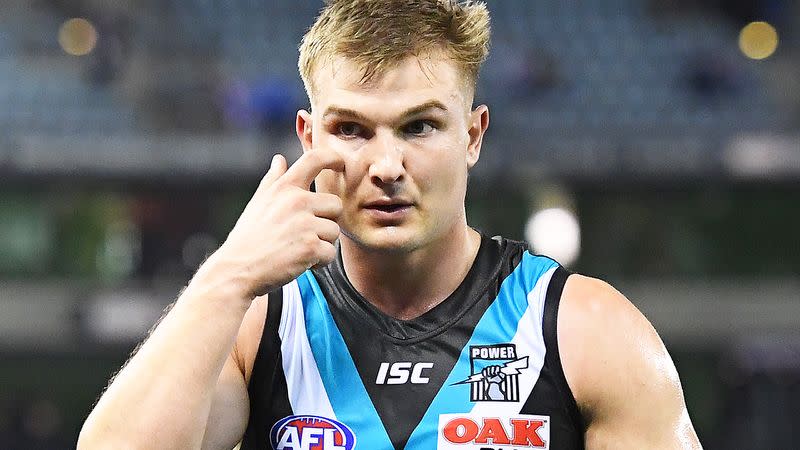 Pictured here, Port Adelaide's Ollie Wines is in hot water over a virus breach.