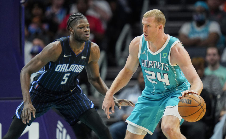 Orlando Magic center Mo Bamba (5) guards Charlotte Hornets center Mason Plumlee (24) during the first half of an NBA basketball game on Thursday, April 7, 2022, in Charlotte, N.C. (AP Photo/Rusty Jones)