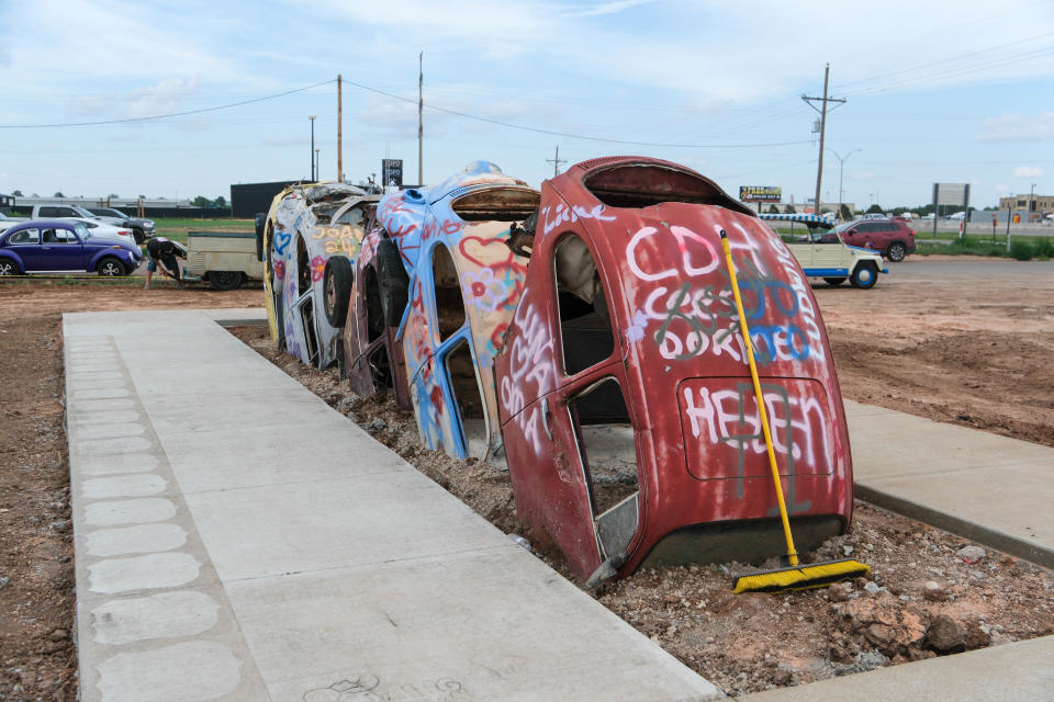 A row of Volkswagen Beetles await spray paint Friday at the christening of the new Big Texan Route 66 Bug Ranch in Amarillo.