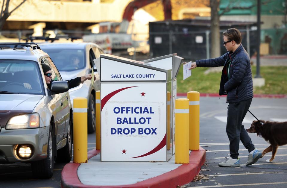 Voters place their ballots into a secure ballot drop box at the Salt Lake County Government Center in Salt Lake City on Wednesday, Nov. 21, 2023. | Laura Seitz, Deseret News