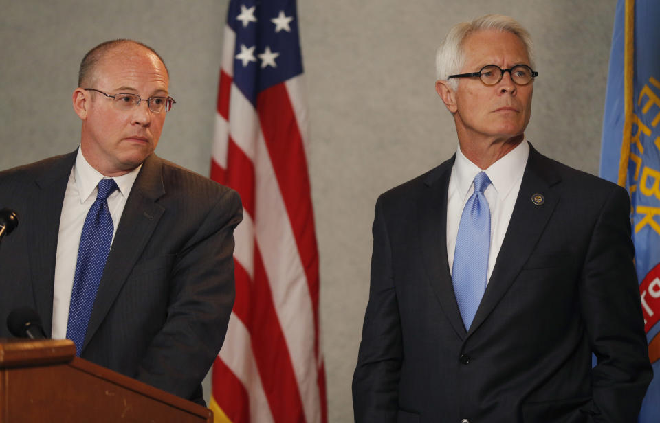 U.S. Attorney Berry Grissom, right, and Johnson County District Attorney Steve Howe, left, listen to a question during a news conference in Overland Park, Kan., Tuesday, April 15, 2014. Kansas prosecutors filed state-level murder charges Tuesday against white supremacist, Frazier Glenn Cross, who is accused in a shootings that left three people dead at two Jewish community sites in suburban Kansas City on Sunday. (AP Photo/Orlin Wagner)