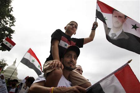 Syrian Americans rally in support of the regime of Syrian President Bashar al-Assad and against proposed U.S. military action against Syria, in a park at the U.S. Capitol in Washington, September 9, 2013. REUTERS/Jonathan Ernst