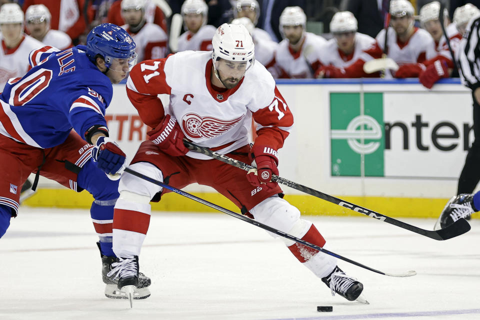 Detroit Red Wings center Dylan Larkin (71) controls the puck past New York Rangers left wing Will Cuylle during the first period of an NHL hockey game Tuesday, Nov. 7, 2023, in New York. (AP Photo/Adam Hunger)