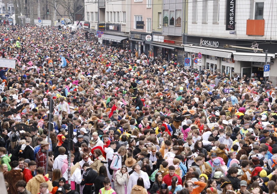 Carnival revellers celebrate with tens of thousands the start of the street carnival Cologne, Germany, Thursday, Feb. 16, 2023. (Thomas Banneyer/dpa via AP)