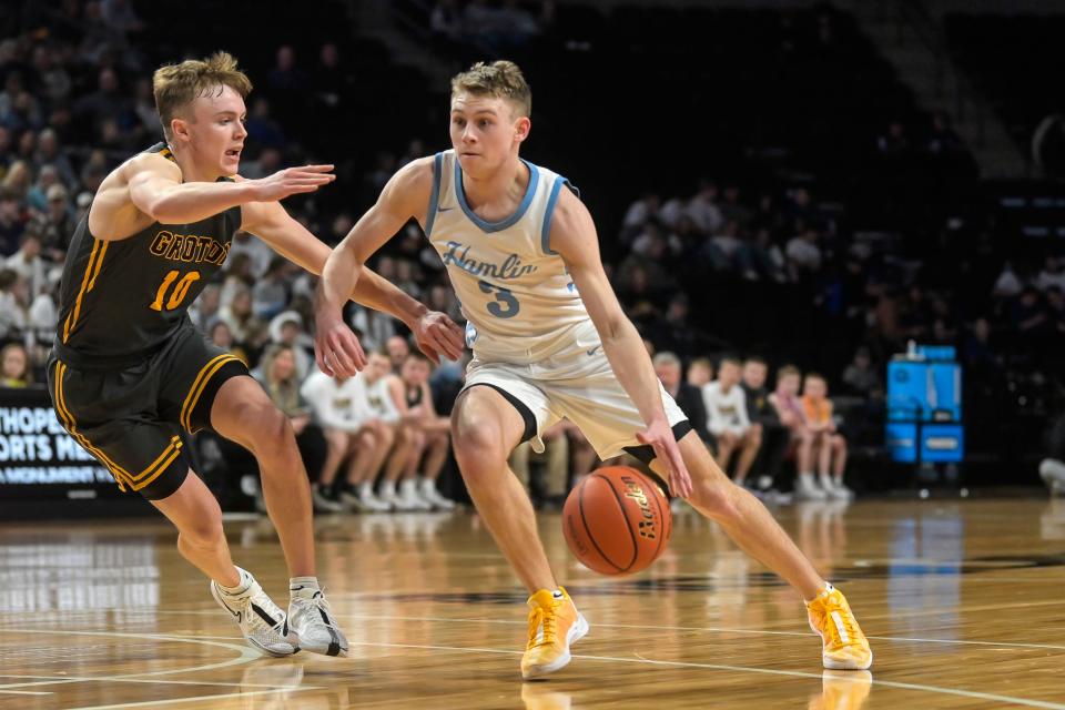 Hamlin's Easton Neuendorf (3) drives to the basket as Groton's Lane Tietz (10) defends during their opening-round game against Groton Area in the state Class A boys basketball tournament on Thursday, March 14, 2024 in the Summit Arena at The Monument in Rapid City. Hamlin won 46-45.