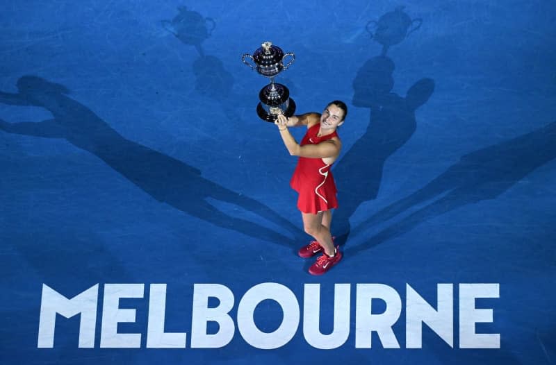 Belarusian tennis player Aryna Sabalenka poses with the Daphne Akhurst Memorial Trophy after defeating China's Qinwen Zheng during their women's singles final tennis match of the 2024 Australian Open at Melbourne Park. James Ross/AAP/dpa