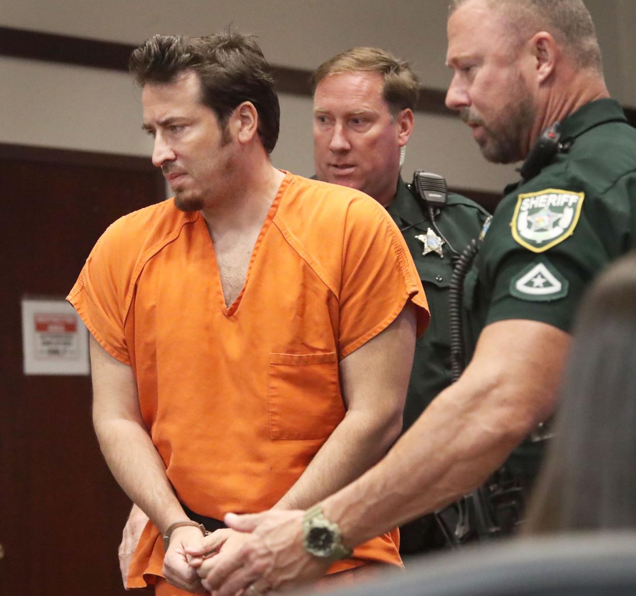 Arin Hankerd, the former Atlantic High School teacher and coach charged with sexual offenses involving students, is escorted to the defense table, Wednesday, May 24, 2023, during a hearing at the S. James Foxman Justice Center in Daytona Beach.