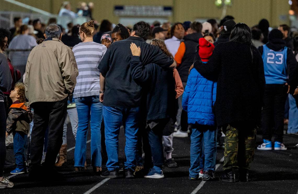 Mourners rgather at the conclusion of a vigil Wednesday, Jan. 24, 2024 on the track of Charles T. Tucker Stadium at Smithfield-Selma High School in Johnston County. Five Smithfield-Selma students were memorialized including four boys who died in a car wreck early Monday morning.